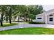 Manicured front yard with a circular driveway and mature trees providing ample shade at 100 Demens St, Oakland, FL 34760