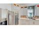 Bright kitchen featuring white cabinets, stainless steel appliances, and a view to the backyard at 100 Demens St, Oakland, FL 34760