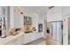 Modern white kitchen with stainless steel appliances, marble countertops, and stylish backsplash at 100 Demens St, Oakland, FL 34760