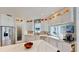 Modern kitchen with white cabinetry, stainless steel appliances, and a stylish island at 100 Demens St, Oakland, FL 34760