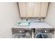 Well-equipped laundry room with modern LG washer and dryer and plenty of upper cabinet storage space at 100 Demens St, Oakland, FL 34760