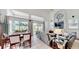 Spacious living room with high ceilings, large windows, leather seating, and adjacent dining area at 100 Demens St, Oakland, FL 34760