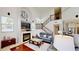Comfortable living room with a fireplace, staircase, and large television over the mantle at 100 Demens St, Oakland, FL 34760