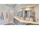 Bright bathroom featuring marble tile, double sinks, vanity, and a walk-in shower at 100 Demens St, Oakland, FL 34760
