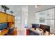 Well-lit office space with built-in wooden cabinets, dual monitors, and view to the entrance at 100 Demens St, Oakland, FL 34760