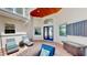 Outdoor patio area featuring stylish blue and white furniture and comfortable seating beneath a skylight at 100 Demens St, Oakland, FL 34760