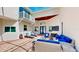 Outdoor patio area featuring stylish blue and white furniture and comfortable seating beneath a skylight at 100 Demens St, Oakland, FL 34760