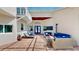 A covered patio with brick floors and ample seating featuring a glass roof and access to the home at 100 Demens St, Oakland, FL 34760