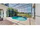Enclosed in-ground pool and patio, with lush landscaping and a screened enclosure at 100 Demens St, Oakland, FL 34760