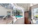 Inviting view of the screened-in pool area with ample seating and lush landscaping at 100 Demens St, Oakland, FL 34760