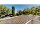 Overhead view showcasing the roof of the home and the lush surroundings with trees and the street at 100 Demens St, Oakland, FL 34760