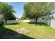 Spacious backyard with lush green grass and a white fence for privacy, perfect for outdoor activities at 10076 Kimble Field Way, Orlando, FL 32827