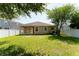 This backyard is fenced-in and has a covered patio with access to the home at 10076 Kimble Field Way, Orlando, FL 32827