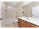 Bright bathroom with tiled floors, a tub and shower combination, and a vanity at 10076 Kimble Field Way, Orlando, FL 32827
