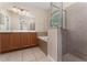 This primary bathroom has a double vanity, soaking tub, and glass-enclosed shower at 10076 Kimble Field Way, Orlando, FL 32827