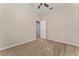 This bedroom features neutral walls, tan carpet, a ceiling fan, and white trim at 10076 Kimble Field Way, Orlando, FL 32827