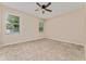 This bedroom features neutral walls, tan carpet, and two windows with blinds at 10076 Kimble Field Way, Orlando, FL 32827