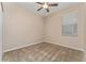 Cozy bedroom with neutral carpet, ceiling fan, window with blinds, offering a simple and clean space at 10076 Kimble Field Way, Orlando, FL 32827
