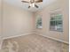 Bright bedroom featuring neutral carpet, ceiling fan, and two windows with blinds for natural light at 10076 Kimble Field Way, Orlando, FL 32827