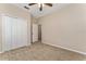 Comfortable bedroom with neutral carpet, closet, ceiling fan, and a doorway to another room at 10076 Kimble Field Way, Orlando, FL 32827