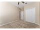 Cozy carpeted bedroom featuring a ceiling fan and a closet for ample storage at 10076 Kimble Field Way, Orlando, FL 32827