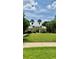 Charming community clubhouse with a well-manicured lawn and mature trees at 10076 Kimble Field Way, Orlando, FL 32827