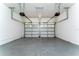 This large garage has two doors and a grey concrete floor at 10076 Kimble Field Way, Orlando, FL 32827