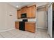 Well-equipped kitchen boasting wood cabinets, black appliances, and tile flooring at 10076 Kimble Field Way, Orlando, FL 32827