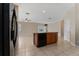 Kitchen island with storage and dishwasher in an open-concept area with tile flooring at 10076 Kimble Field Way, Orlando, FL 32827