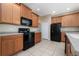 Kitchen with stainless steel appliances, ample cabinet space, and tile flooring at 10076 Kimble Field Way, Orlando, FL 32827