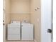 This laundry room features a washer, dryer, and wire shelving at 10076 Kimble Field Way, Orlando, FL 32827
