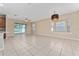 Spacious living room with tile flooring, bay window and sliding glass door to the backyard at 10076 Kimble Field Way, Orlando, FL 32827