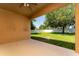 This covered patio has a view of the backyard and the white fence at 10076 Kimble Field Way, Orlando, FL 32827