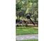 A community playground featuring a slide and climbing structures with protective fencing at 10076 Kimble Field Way, Orlando, FL 32827