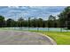 A well-maintained community tennis court with a green and blue surface surrounded by a secure fence at 10076 Kimble Field Way, Orlando, FL 32827