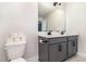 Bathroom featuring a double vanity, a large mirror, and a nearby toilet at 1073 River Otter Way, Deland, FL 32720