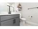 Modern bathroom featuring a sleek gray vanity, updated fixtures, and lots of open space at 1073 River Otter Way, Deland, FL 32720