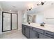 Well-lit bathroom features a double vanity and walk-in glass shower at 1073 River Otter Way, Deland, FL 32720