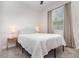 Cozy bedroom with carpet flooring, a comfortable bed, neutral walls, and a view to the outside at 1073 River Otter Way, Deland, FL 32720