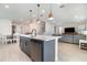 Stylish kitchen featuring a center island, barstool seating, stainless steel appliances, and tile flooring at 1073 River Otter Way, Deland, FL 32720