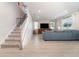 Open-concept living room featuring tile flooring, neutral walls, a staircase and lots of natural light at 1073 River Otter Way, Deland, FL 32720