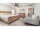 A roomy main bedroom featuring a ceiling fan, a couch, and an ensuite at 1073 River Otter Way, Deland, FL 32720