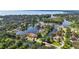 Aerial view of a waterfront community surrounded by lush green landscape and waterways at 1085 Island Way, Leesburg, FL 34748