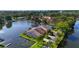 Scenic waterfront townhomes with boat docks on a tranquil lake, framed by palm trees and green lawns at 1085 Island Way, Leesburg, FL 34748