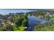 Aerial view of a lake community with beautiful green landscaping, mature trees and several private boat docks at 1085 Island Way, Leesburg, FL 34748