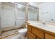 Bright bathroom featuring a toilet and shower with sliding glass doors at 1085 Island Way, Leesburg, FL 34748