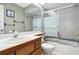 A bathroom features a shower/tub with sliding doors, sink and wallpapered walls at 1085 Island Way, Leesburg, FL 34748