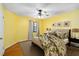 Cozy bedroom with wood floors, a floral patterned comforter, and natural light at 1085 Island Way, Leesburg, FL 34748