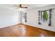 Bedroom with wood flooring, two windows, and neutral paint at 1085 Island Way, Leesburg, FL 34748