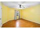 Sunny yellow bedroom with wood floors and a window at 1085 Island Way, Leesburg, FL 34748